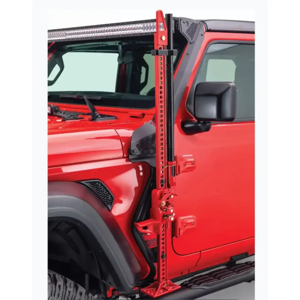 Jack Mount Hi-Lift Jack by Go Rhino mounted to driver side front quarter panel of a red Jeep Wrangler, black mild steel, powder-coated finish.