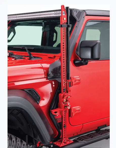 Jack Mount Hi-Lift Jack by Go Rhino mounted to driver side front quarter panel of a red Jeep Wrangler, black mild steel, powder-coated finish.