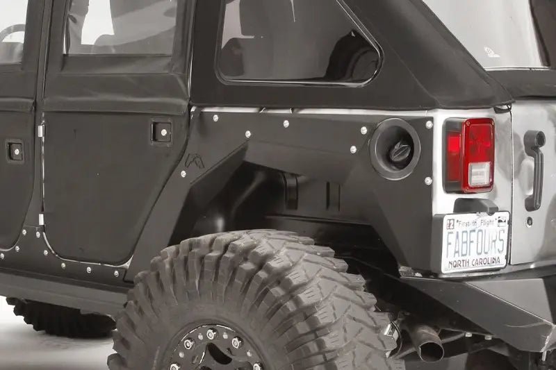Close-up view of the Fab Fours JK1001-1 rear fender installed on a Jeep Wrangler JK, showcasing its durable and sleek design.