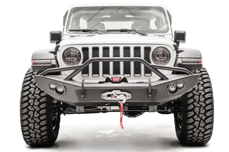 Front view of a white Jeep featuring the JL18-B4652-1 Fab Fours Lifestyle Winch Bumper with Guard, showcasing its robust design and integrated winch for enhanced off-road functionality.
