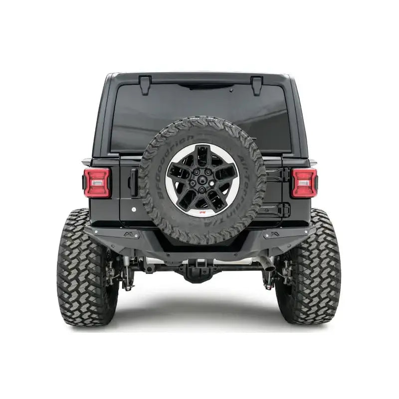Fab Fours 18 Jp Jl Rear Base (JL18-Y1851-1) installed on a Jeep Wrangler, providing enhanced protection and rugged style for tough off-road conditions.