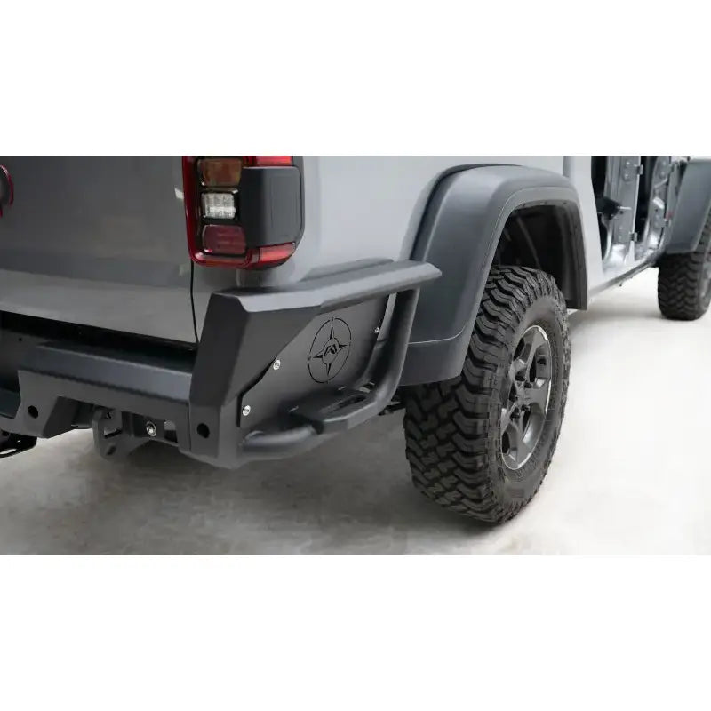JT20-Y1950-1 Fab Fours Gladiator Rear bumper installed on a rugged off-road vehicle showcasing superior protection and aggressive styling.