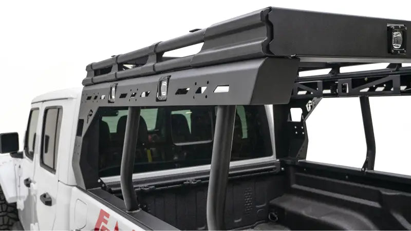 JTOR-01-1 Fab Fours Gladiator Overland Rack mounted on Jeep Gladiator, showcasing durable construction, aerodynamic design, and ample storage for off-road adventures.