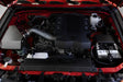 Red engine bay with black engine in a Toyota 4Runner performance air intake system