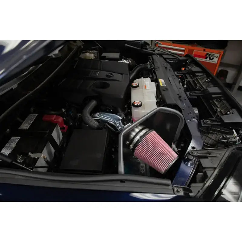 K&N 2022 Toyota Tundra V6-3.5L F/I Performance Air Intake System with mandrel-bent aluminum intake tube and conical High-Flow Air Filter installed in an engine bay.