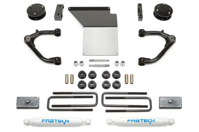 K1062 Fabtech Lift Kit Suspension components laid out, including control arms, bolts, spacers, and Fabtech-branded shock absorbers.