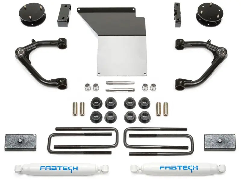 K1062 Fabtech Lift Kit Suspension components arranged on a white background illustrating various parts including U-bolts, shock absorbers, and control arms designed for superior lift and enhanced suspension performance.