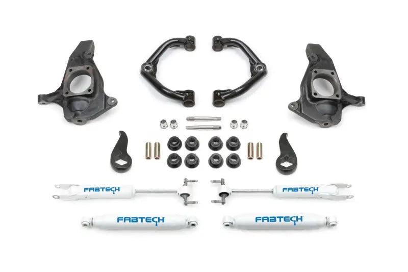 K1064 Fabtech Leveling Kit Suspension - components arranged, including control arms, shocks, torsion keys, and mounting hardware, enhances ground clearance and vehicle performance.