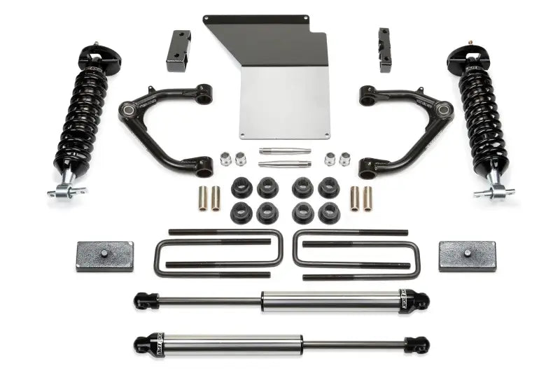 Fabtech K1071DL Lift Kit Suspension components including shock absorbers, control arms, bolts, and brackets designed for enhanced ground clearance and off-road performance.
