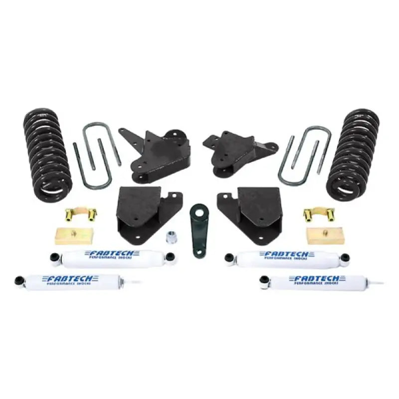 Fabtech K2100 Lift Kit Suspension components laid out, including shock absorbers, coil springs, brackets, and hardware for enhancing off-road performance and ground clearance.