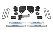 K2213 Fabtech Lift Kit Suspension components for vehicle upgrade, including shock absorbers, mounting brackets, U-bolts, and additional hardware for enhanced off-road performance and larger tire fitment.