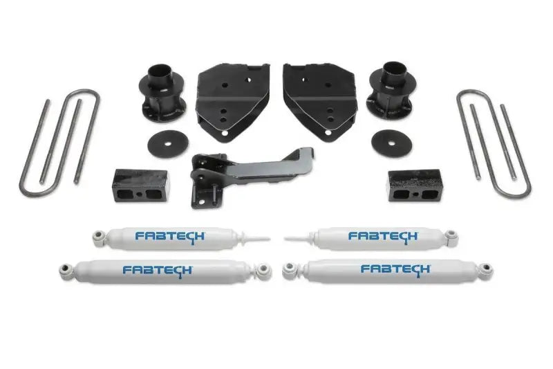 K2213 Fabtech Lift Kit Suspension components for vehicle upgrade, including shock absorbers, mounting brackets, U-bolts, and additional hardware for enhanced off-road performance and larger tire fitment.