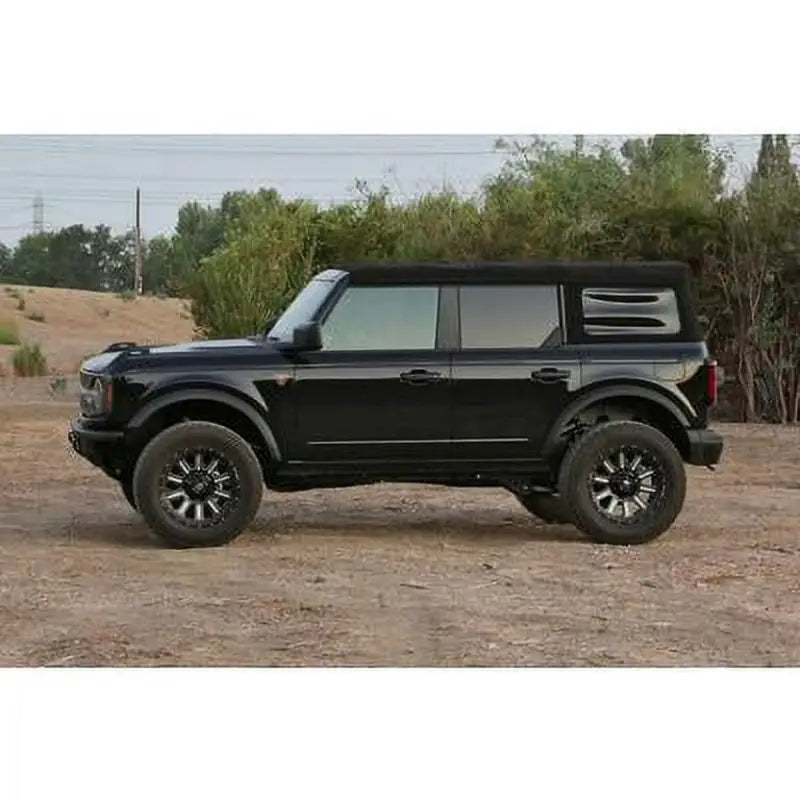 Black off-road vehicle enhanced with K2382 Fabtech 3' Uca Kit w/Uniballs & Lower Link Kit for superior performance and control.