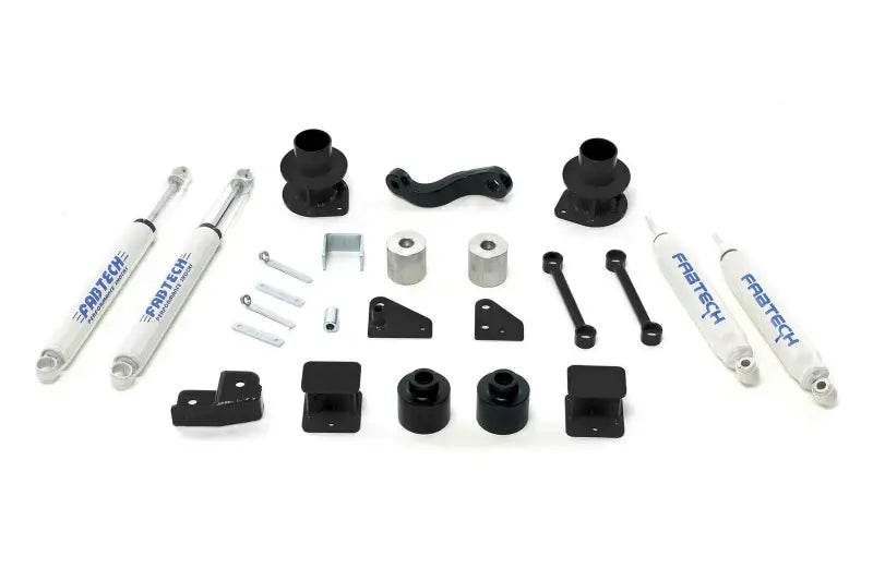 Fabtech K4037 Lift Kit Suspension components arrayed on plain background showcasing shocks, brackets, and hardware.