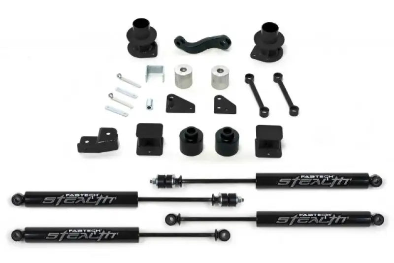Fabtech K4037M Lift Kit Suspension components laid out, featuring shocks, spacers, and mounting hardware for enhanced vehicle performance.
