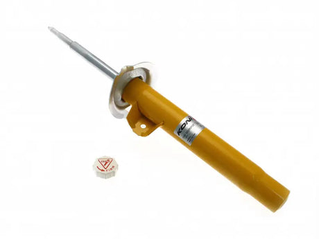 Yellow KONI shock absorber with adjustment cap.