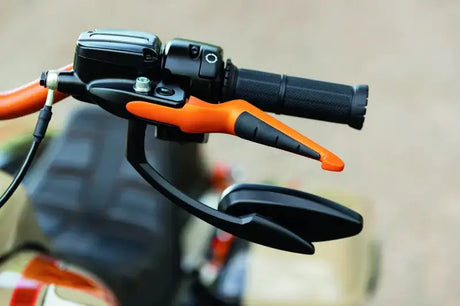 Motorcycle handlebar with orange brake lever and black mirror, Kuryakyn ISO levers