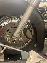Motorcycle front wheel assembly with Kuryakyn Mesh Caliper Covers Black for style
