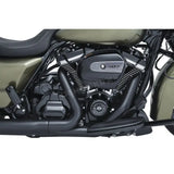 Motorcycle engine with black exhaust pipes showcasing Kuryakyn precision tappet block accent