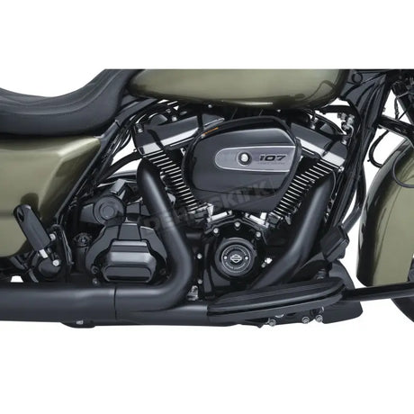 Motorcycle engine with black exhaust pipes showcasing Kuryakyn precision tappet block accent