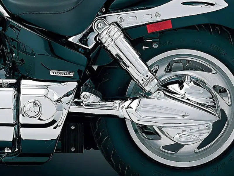 Chrome motorcycle rear suspension with Kuryakyn Primary Cover Service Kit installed