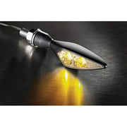 Illuminated satin black Kuryakyn Rhombus Amber left rear motorcycle turn signal