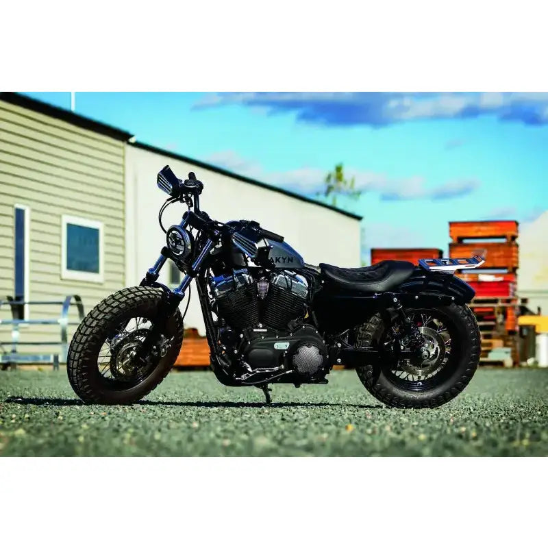 Kuryakyn Thresher Grips Dual Cable Black installed on a sleek black motorcycle, showcasing ergonomic design and durable construction.
