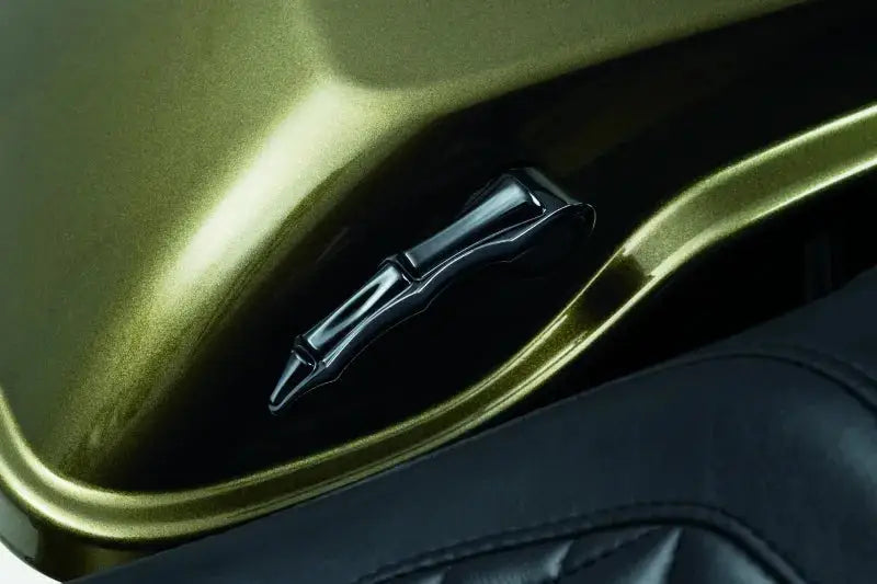 Black Kuryakyn Zombie Saddlebag Latch Handle with gold fuel tank