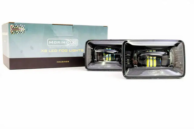 LF150 Morimoto Xb LED Fogs Type F2 Pair with advanced Morimoto Xb LED technology, showcased with original packaging in the background.