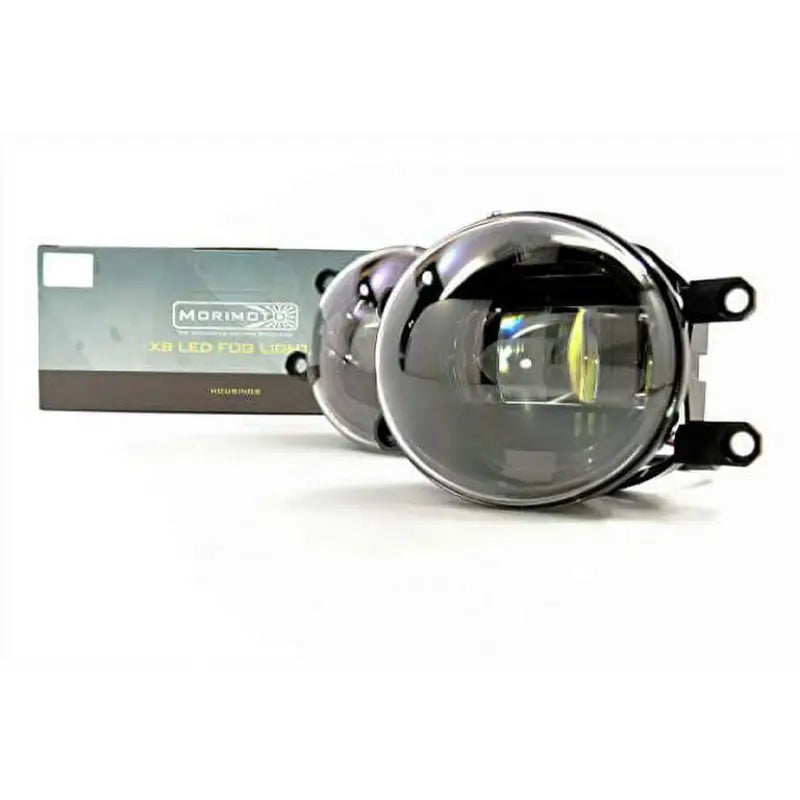 LF220 Morimoto Mrm Xb Ld Fogs Type T Pr Wht Light, high-quality fog light set with enhanced visibility and stylish design, easy installation, and durable construction, showcased in front of packaging.