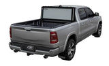 Silver pickup truck with open Lomax Stance Hard Cover on 19+ Ram 2500/3500 box