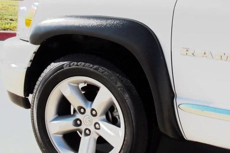 White Ram truck front quarter with Lund ex-extrawide style textured black fender flares