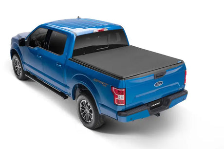 Blue Ford pickup with Genesis Elite Tri-Fold Tonneau Cover on 5.5ft Bed