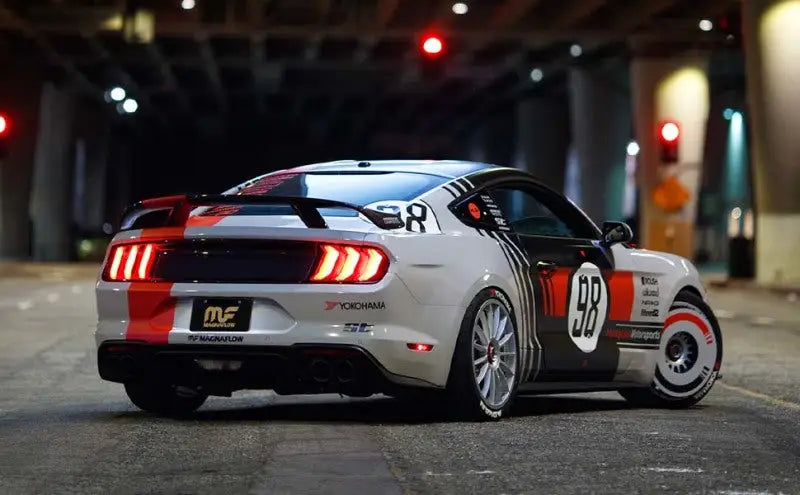 White Ford Mustang with racing stripes, shown off for Subaru WRX STI car upgrade