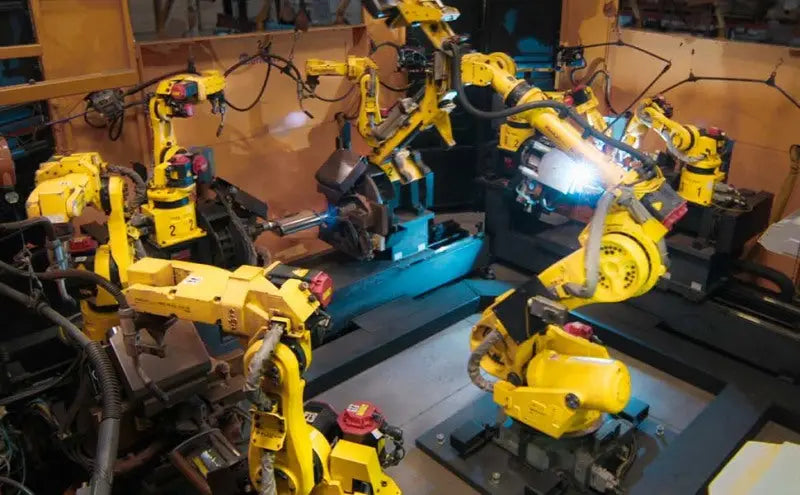 Yellow industrial robotic arms on MagnaFlow Sys CB 07 GM Tahoe / Yukon 5.3L V8