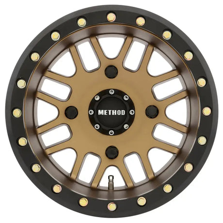 Method MR406 UTV beadlock wheel with bronze finish, black rim, and exposed gold bolts