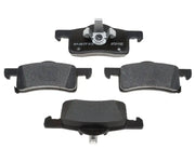 Four black brake pads from MGD935C R/M Brake Pad Set, perfect for your brake pad set needs