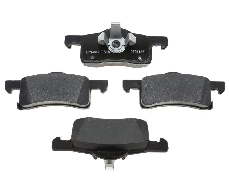 Four black brake pads from MGD935C R/M Brake Pad Set, perfect for your brake pad set needs