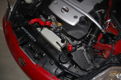 Car engine compartment with Mishimoto 07-09 Nissan 350Z red silicone hose kit