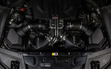 Car engine compartment with Mishimoto BMW F10 M5 intercooler kit in wrinkle black