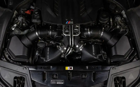 Car engine compartment with Mishimoto BMW F10 M5 intercooler kit in wrinkle black
