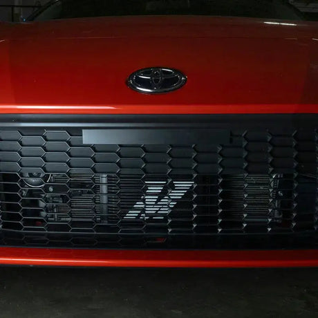 Red car front grill with Mishimoto 22+ Subaru BRZ Toyota GR86 oil cooler kit