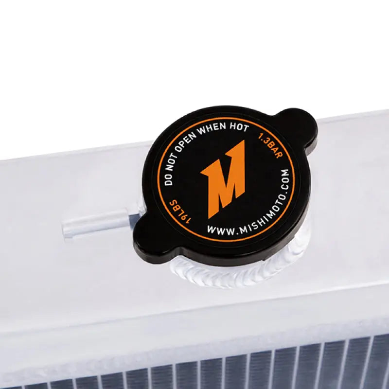Black radiator cap with orange logo on Mishimoto Plymouth Barracuda big block aluminum radiator