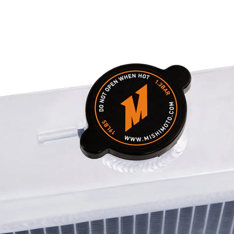 Black radiator cap with orange logo on Mishimoto Plymouth Barracuda big block aluminum radiator