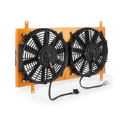 Dual electric cooling fans with orange mounting bracket on Mishimoto Mazda Miata aluminum fan shroud