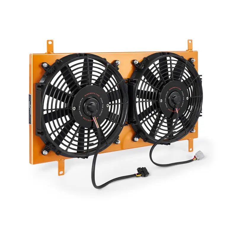 Dual electric cooling fans with orange mounting bracket on Mishimoto Mazda Miata aluminum fan shroud