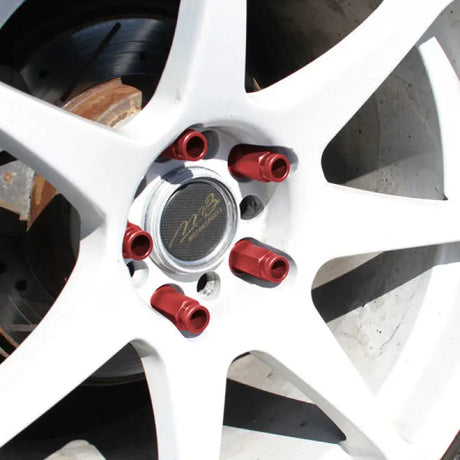 White car wheel with red locking lug nuts for Mishimoto Aluminum Locking Lug Nuts M12 x 1.5 Neo Chrome