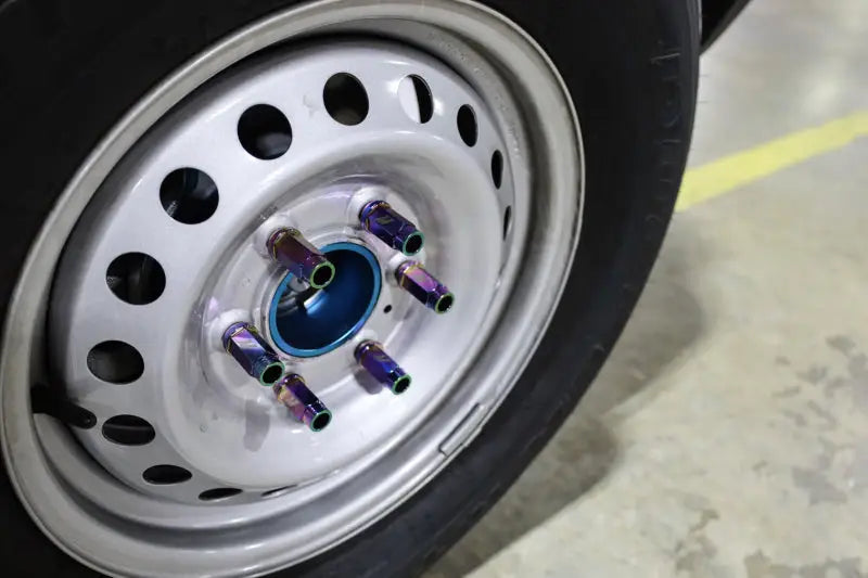Iridescent locking lug nuts on car wheel for Mishimoto Aluminum Locking Lug Nuts M12x1.5