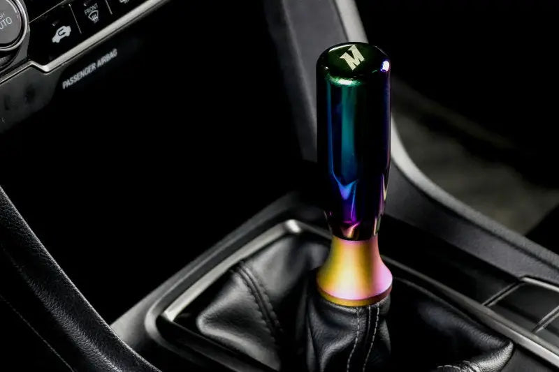 Rainbow-colored manual shift knob with mishimoto shift boot and shift boot retainer