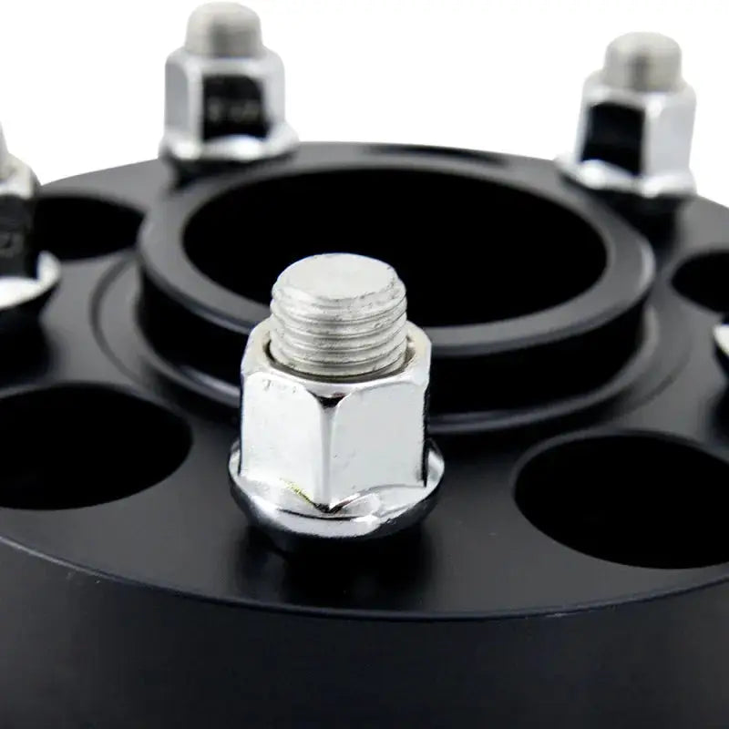 Black wheel spacer with lug nuts from Mishimoto Tesla Wheel Spacer Staggered Bundle 15mm + 20mm